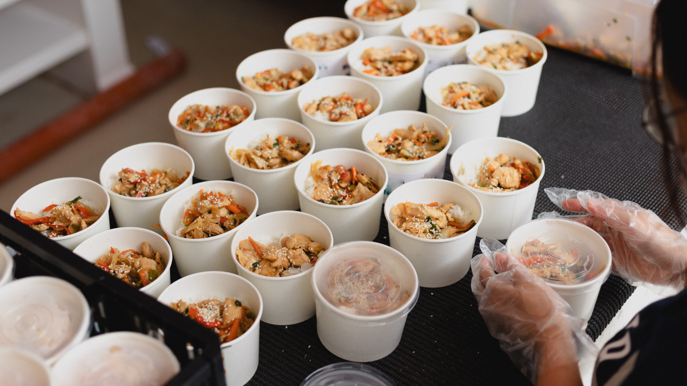 Prepared food containers, symbolizing program delivery and impact.